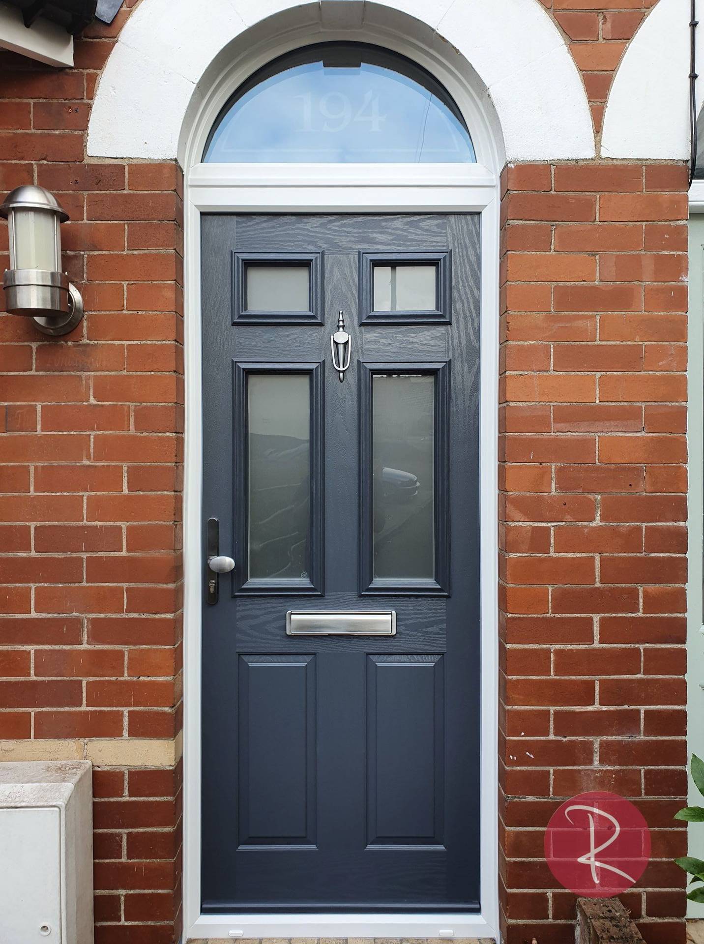 black woodgrain effect composite front door